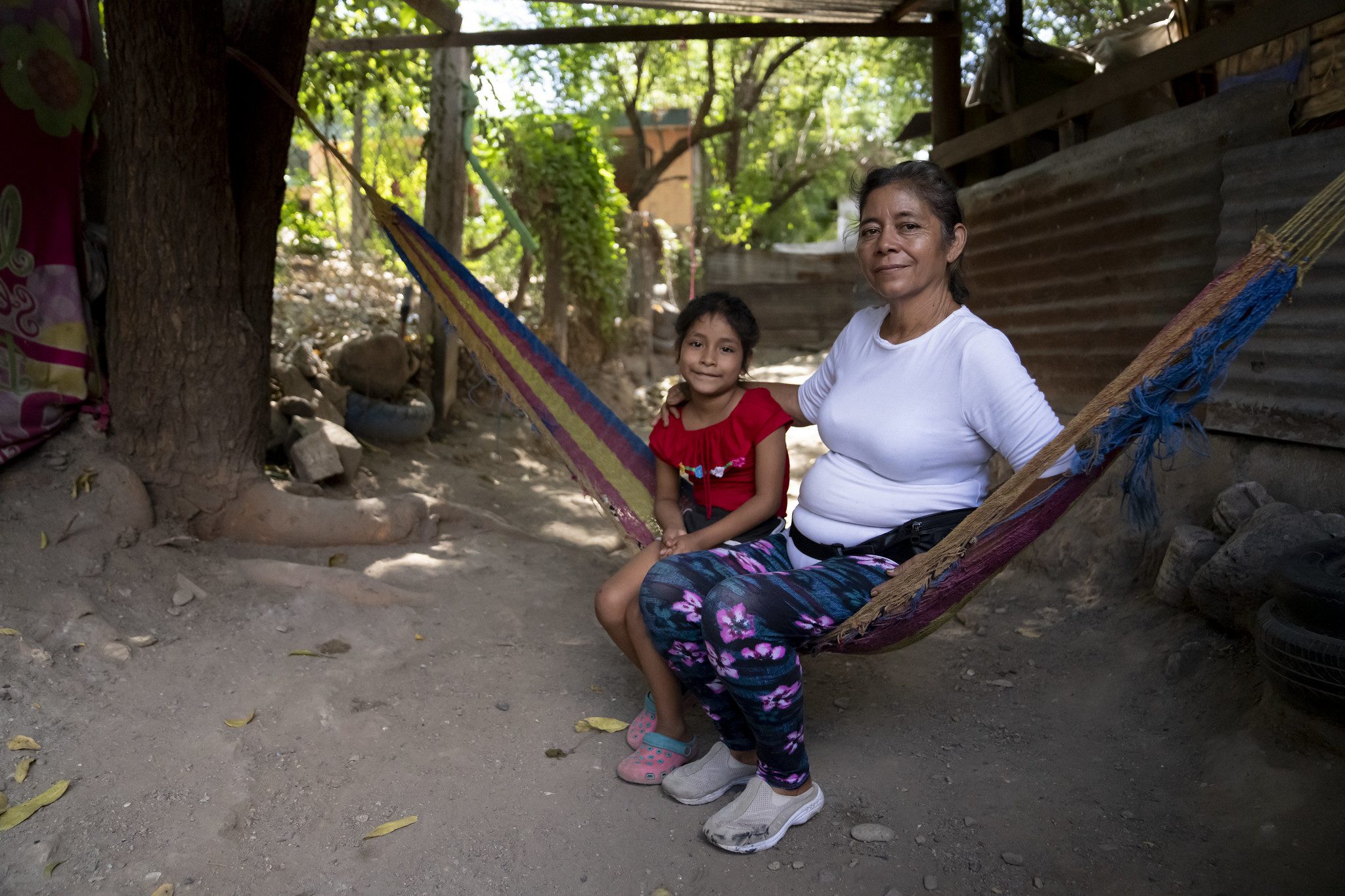 5 December, 2023, Guatemala City, Guatemala: Nora Cruz, a resident of El Rancho, her son, Oscar Cruz , and her granddaughter, Enma Lopez, at their home. Their family is a beneficiary of donation parcels ferried in to the small town by the Guatemala City based food bank, Desarrollo en Movimiento. A traffic accident left Oscar unable to work and relies on Nora's solely to provide for the family. (Photo: The Global FoodBanking Network/Tomas Ayuso)